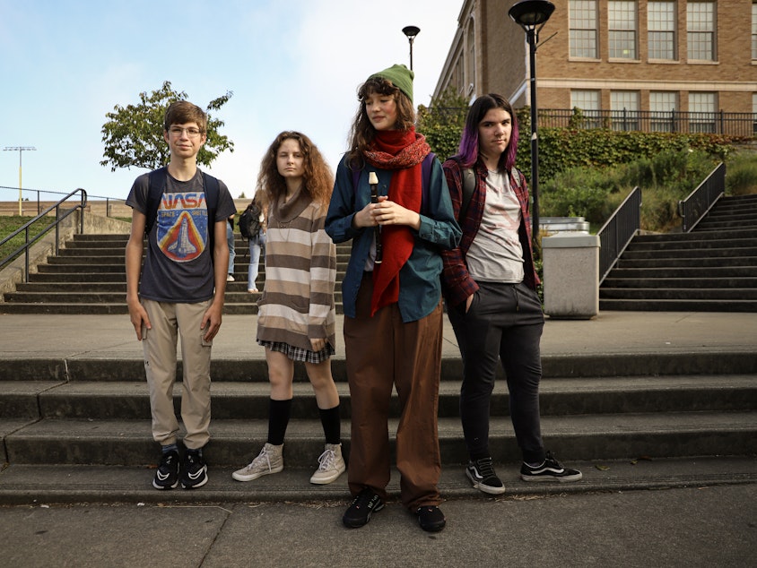 caption: From left to right, juniors TJ Leis, Reed Sneed, Shasta Wiswell, and Beckett Muchmore hang out before the start of classes at Roosevelt High School in Seattle on the first day, September 4, 2024. "I got new clothes, so I may as well wear them," said Reed. Their friend Shasta said she was cosplaying as Sou Hiyori from "Your Time to Die" video game.
