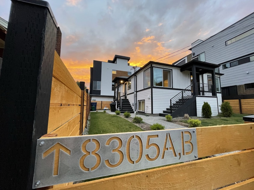 caption: An older house in Greenwood, with new infill housing in the backyard. Projects like this could become more common if density is spread into single-family neighborhoods (currently zoned as "neighborhood residential") across the city.