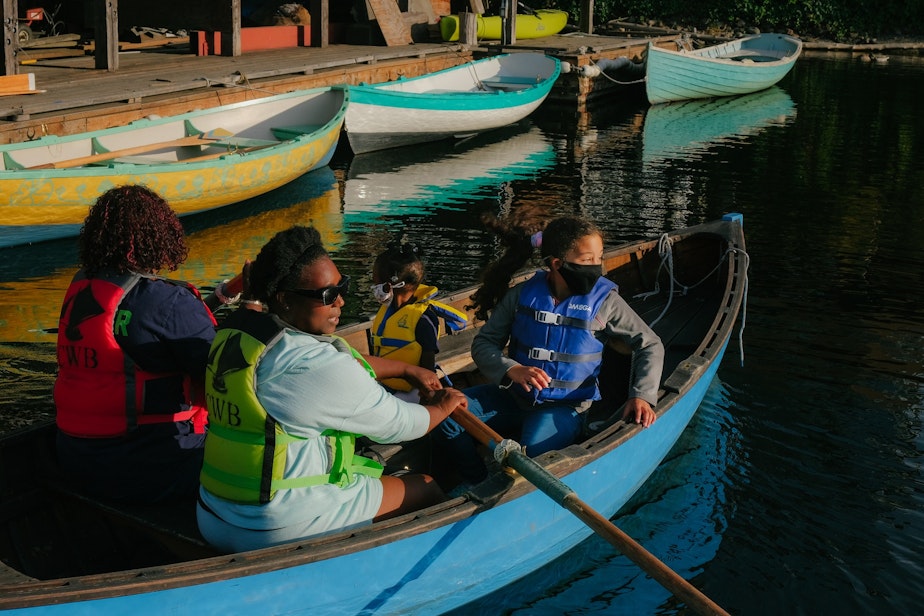 caption: Erica Porter, second from left, her mother Lillian, left, and her two daughters take a peapod row boat out onto Lake Union from the Center for Wooden Boats, September 9, 2021.