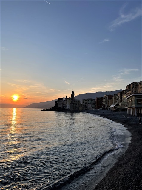caption: The sun sets in Camogli, Italy.