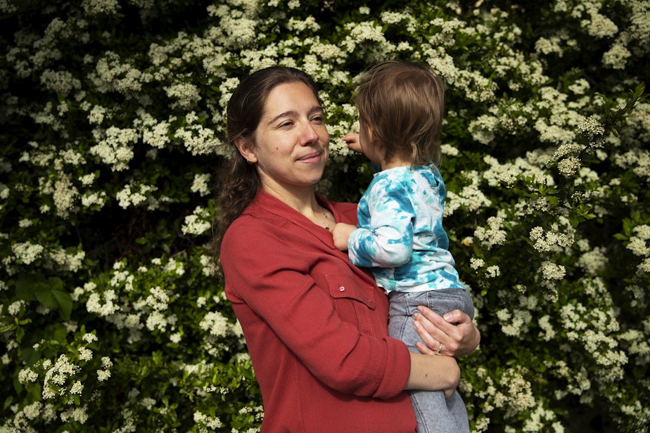 caption: Sonia Dillane holds her 21-month-old daughter at Webster Park on Tuesday, May 23, 2023, in Seattle.