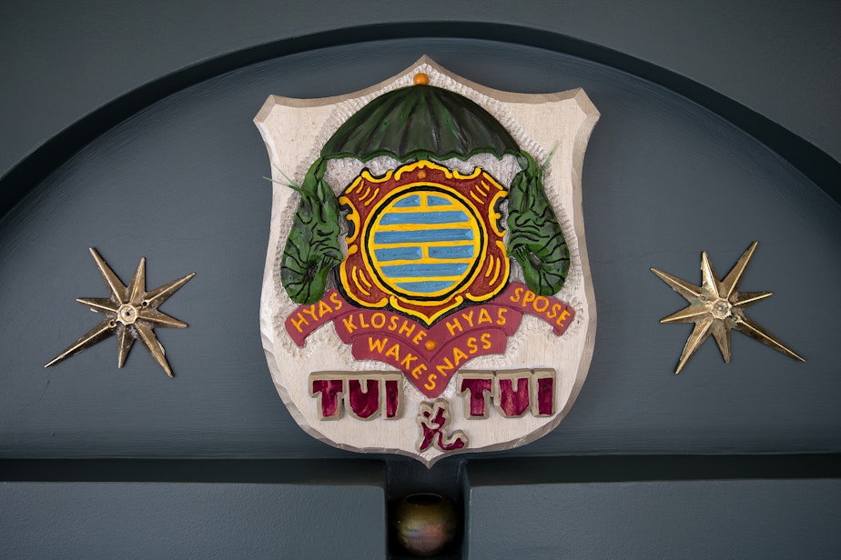 caption: The coat of arms is shown along a wall inside Janet Yoder and Robert Rudine’s houseboat and self-declared sovereign nation Tui Tui, on Tuesday, March 26, 2024, in Seattle.