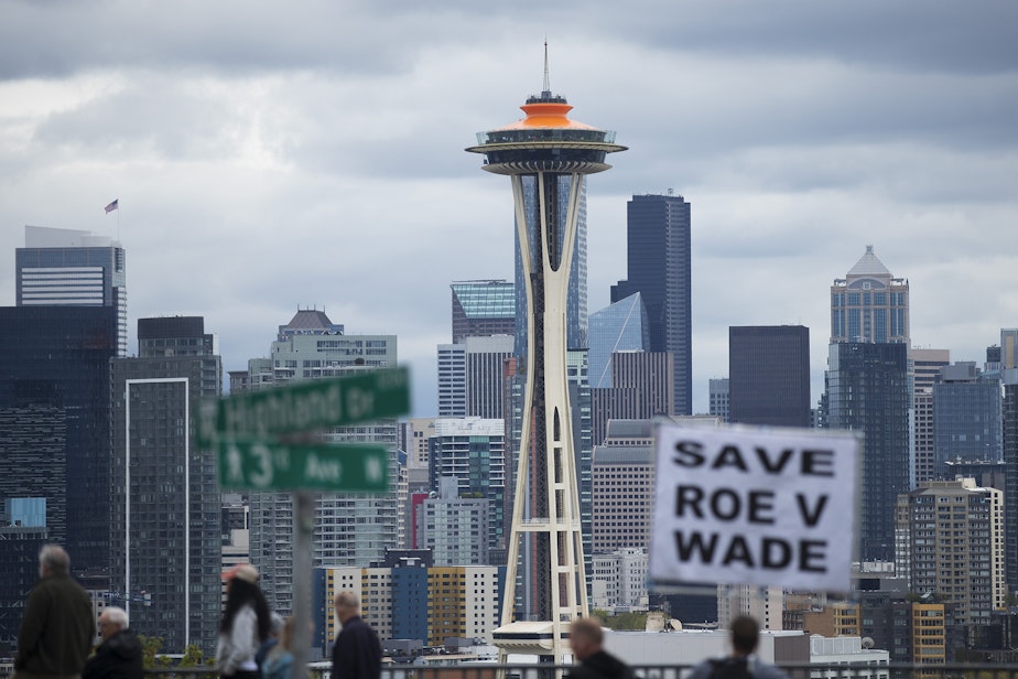 caption: A crowd is gathered during a pro-choice rally and press conference on Tuesday, May 3, 2022, at Kerry Park in Seattle.