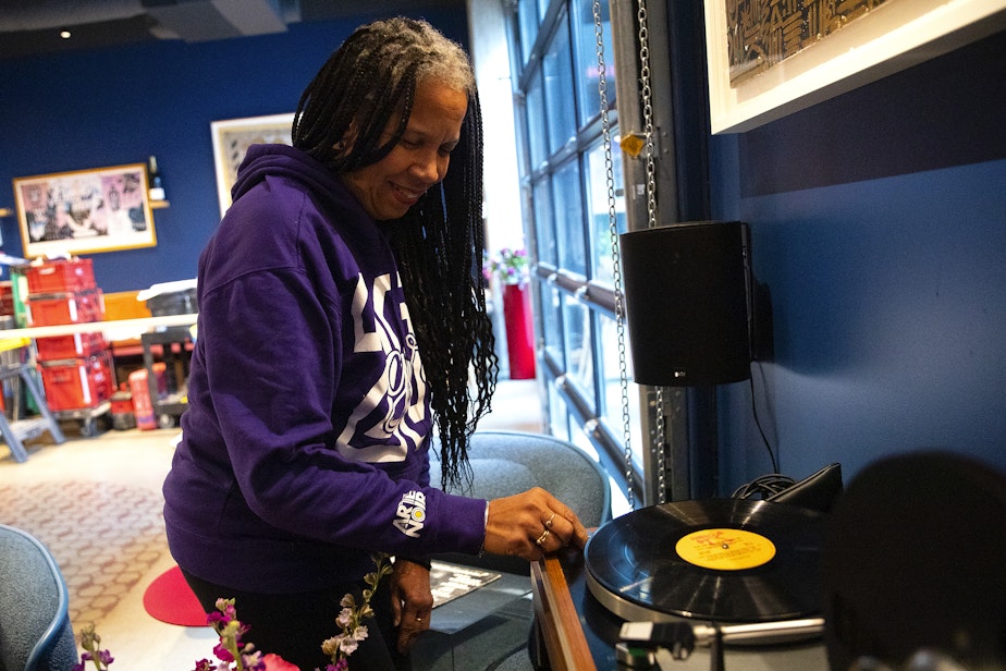 caption: Donna Moodie puts a record on at the new location of Marjorie on Monday, November 25, 2024, in Seattle.