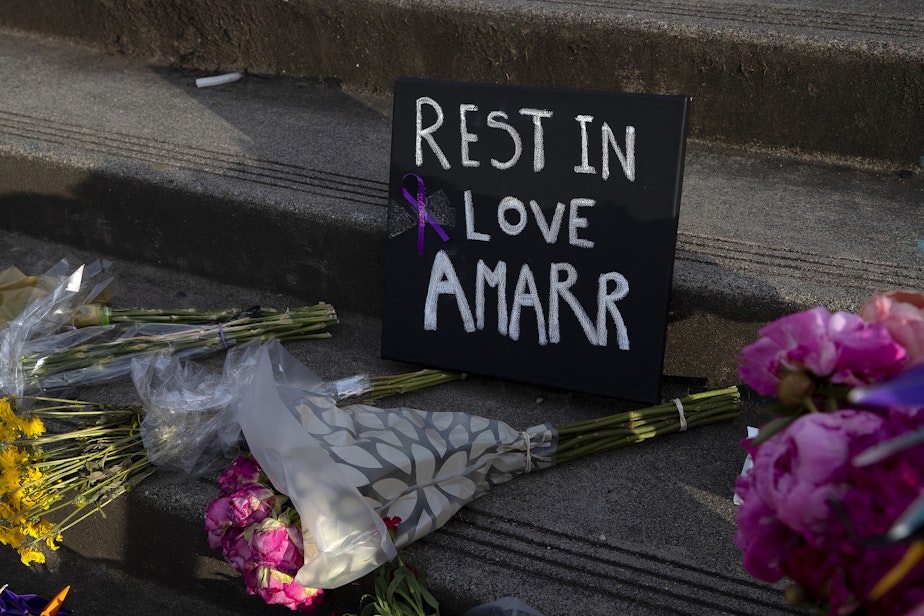 caption: ‘Rest in love Amarr’ reads a sign during a unity walk in honor of 17-year-old Garfield high school student Amarr Murphy-Paine, who was shot and killed at school, on Thursday, June 13, 2024, in Seattle.