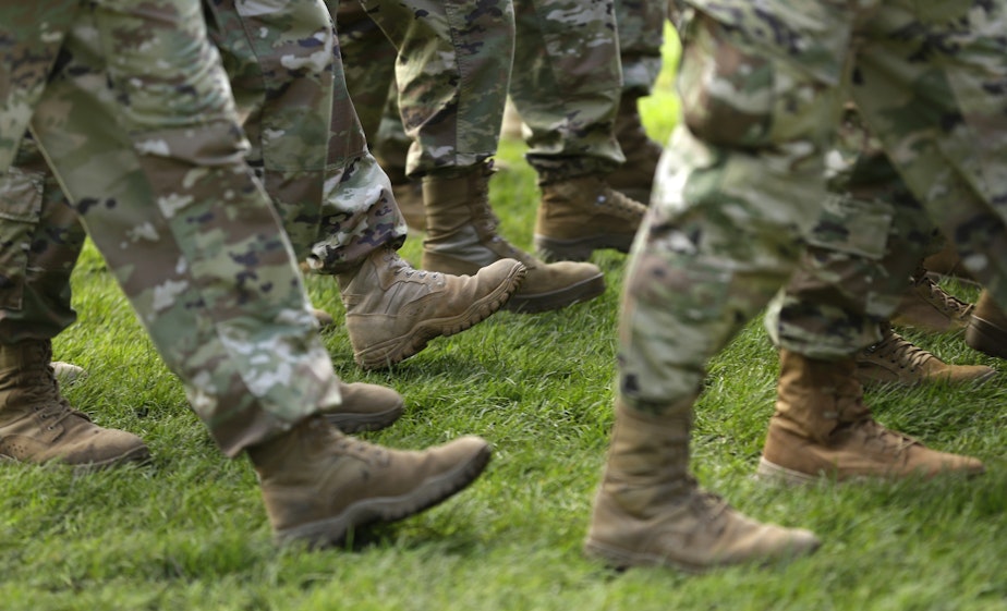 caption: FILE- In this April 3, 2017, file photo U.S. Army soldiers march in formation during a change of command ceremony at Joint Base Lewis-McChord in Washington.