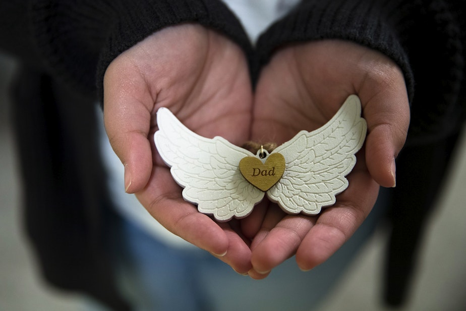 caption: Kaitlyn Mrsny, 13, holds a Christmas ornament dedicated to her father, Kurt Mrsny, on Thursday, December 9, 2022, at their home in Puyallup.