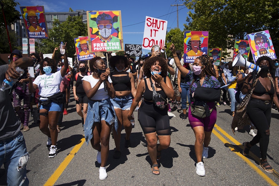 caption: Organizers of the Everyday March lead the Defund The Police march and rally with chants at the beginning of the march from the King County Juvenile Detention Center to Seattle City Hall on Wednesday August 5, 2020, in Seattle.