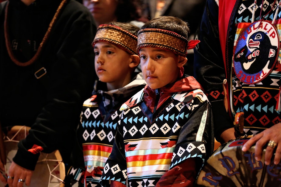 caption: Josh Fryberg Jr (9) center, and Daniel Fryberg (8), left center, during the opening ceremony at the Tulalip Gathering Hall on Sunday in Tulalip.