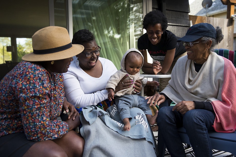 caption: Cassandra Cast, second from left, smiles while holding her 9-month-old grandson, Zoli Rae, next to her daughter, LaTriece Arthur, left, daughter-in-law Christina Arthur, and Christina's mom, Barbara Arthur, right, on Monday, April 19, 2021, at LaTriece and Christina Arthur's home on Vashon Island. Cassandra Cast and Barbara Arthur traveled from Boston and Atlanta, respectively, to meet their grandson Zoli Rae for the first time.