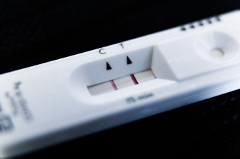 caption: A positive result on a home COVID test. If you catch it once, can you catch it again? Turns out the answer is: Yes.