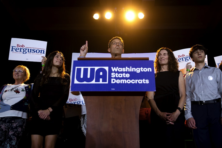 caption: Democratic governor candidate Bob Ferguson speaks to a large crowd on Tuesday, November 5, 2024, during the Washington Democrats election night party at the Seattle Convention Center in Seattle.