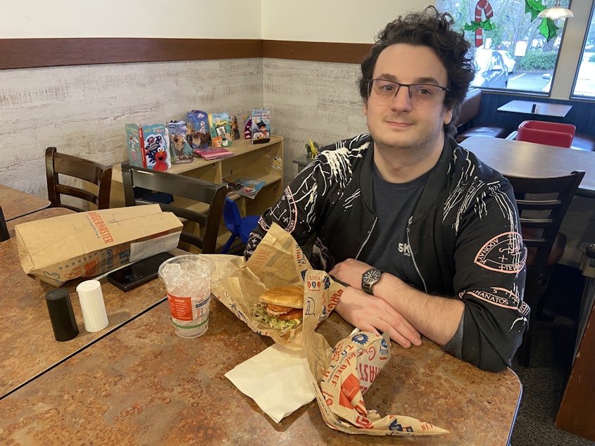 caption: Matthew Becker grabbed a Chickenmaster sandwich for lunch.