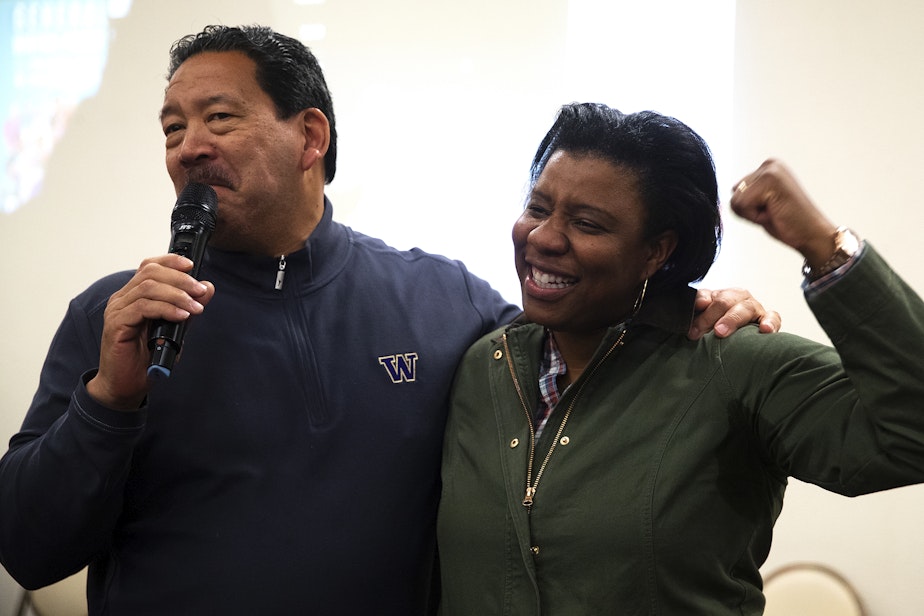caption: Seattle Mayor Bruce Harrell celebrates with Seattle City Council candidate Joy Hollingsworth after initial results showed her in the lead during an election night party at the First AME Church on Tuesday, Nov. 7, 2023, in Seattle.