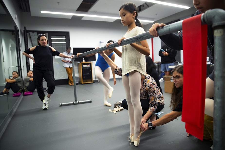 caption: Caroline Antone, 10, has help getting fitted for her first pair of pointe shoes on Tuesday, September 12, 2023, at the Pacific Northwest Ballet School in Bellevue.