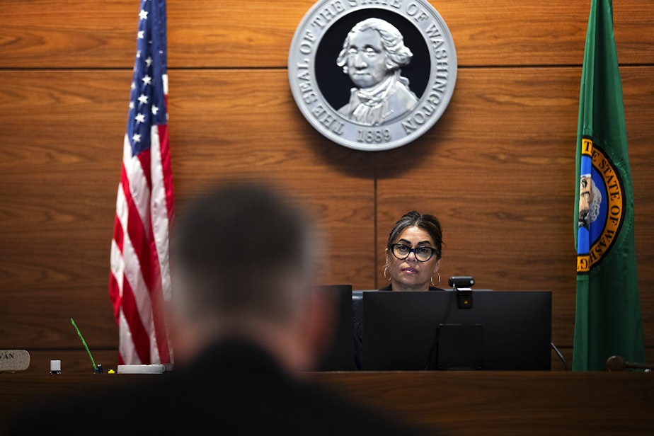 caption: Juvenile probation counselor Dan Baxter, left, speaks with Judge Veronica Galván in juvenile court, on Wednesday, August 14, 2024, at the Judge Patricia H. Clark Children and Family Justice Center in Seattle.