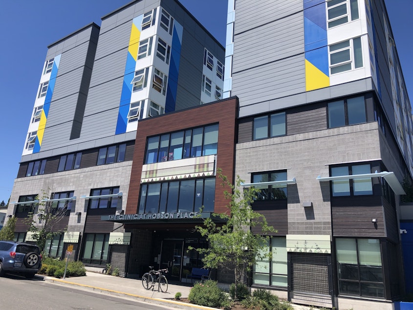 caption: Hobson Place in Rainier Valley contains 177 units of permanent supportive housing. A mother says she wants the staff to do more to stem illicit drug use, which has caused her son's mental health to deteriorate.