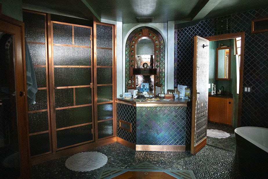 caption: A portion of the interior of Janet Yoder and Robert Rudine’s houseboat, the self declared sovereign nation of Tui Tui, is shown on Tuesday, March 26, 2024, in Seattle.
