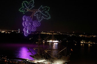 caption: An aerial drone display by approximately 500 drones hovers over the Garonne River in Bordeaux, France on June 23, 2023. Some U.S. cities are planning their own drone shows as an alternative to Fourth of July fireworks.