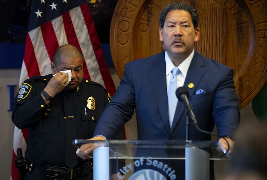 caption: Former police chief Adrian Diaz wipes a tear following Mayor Bruce Harrell’s announcement that he would be stepping down as Seattle’s Chief of Police on Wednesday, May 29, 2024, at City Hall in Seattle.