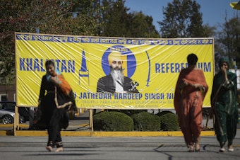 caption: A banner that shows the late Sikh separatist leader Hardeep Singh Nijjar is displayed outside the Guru Nanak Sikh Gurdwara Sahib in Surrey, British Columbia, on Sept. 18, 2023.