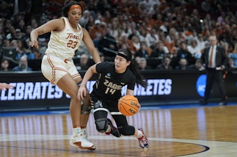 caption: Gonzaga guard Kaylynne Truong (14) tries to move around Texas forward Aaliyah Moore (23) during the second half of a Sweet 16 college basketball game against Texas in the women's NCAA Tournament, Friday, March 29, 2024, in Portland, Ore. Texas won 69-47. 
