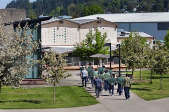 caption: Offenders are escorted across the campus at Green Hill School in Chehalis, Wash. on Wednesday, May 10, 2017. Green Hill is a medium/maximum security, fenced facility for teenage male offenders run by the State Department of Social and Health Services.