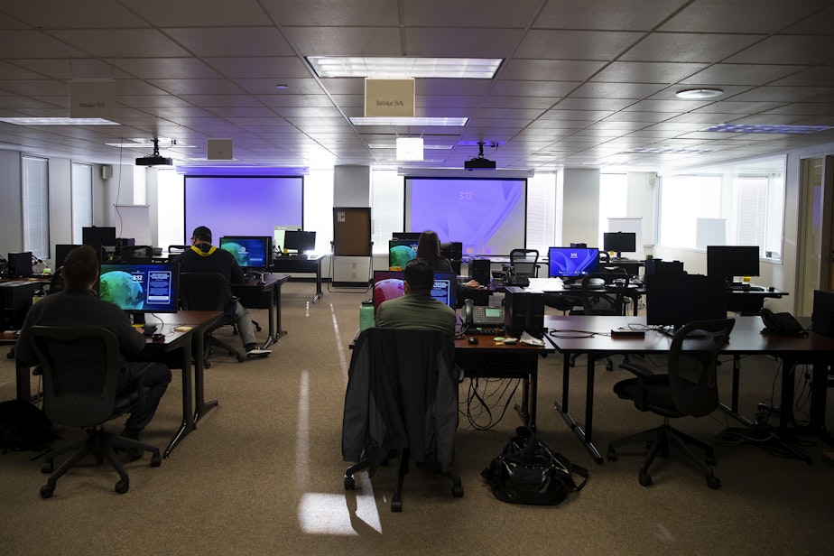 caption: Employees work at the elections command post at the FBI Seattle field office on Monday, November 4, 2024, in Seattle.