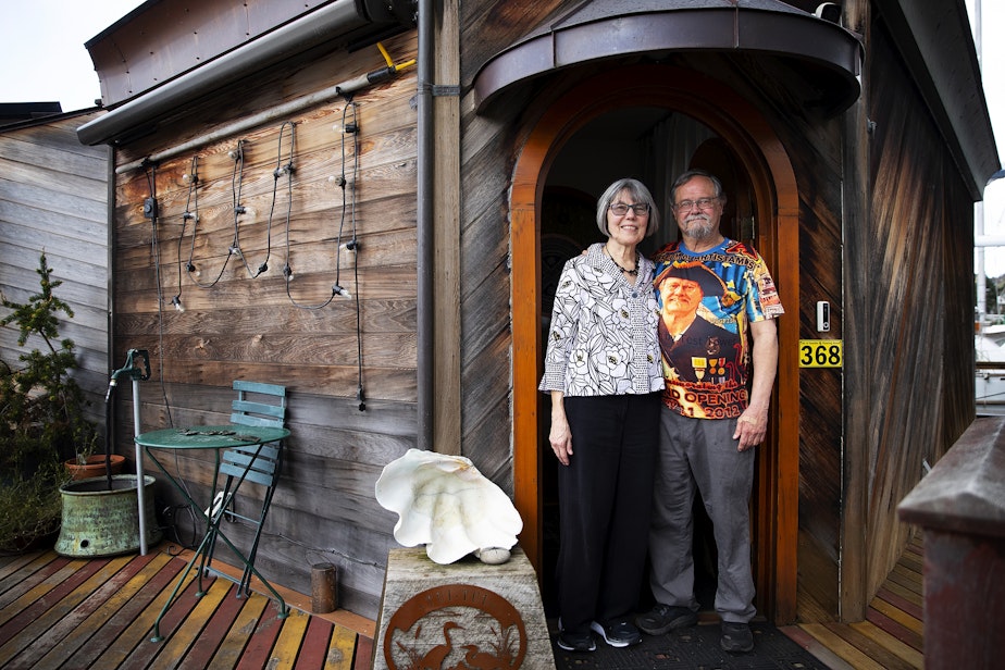 caption: Janet Yoder and Robert Rudine are portrayed on their houseboat, the self-declared sovereign nation of Tui Tui, on Tuesday, March 26, 2024, in Seattle.